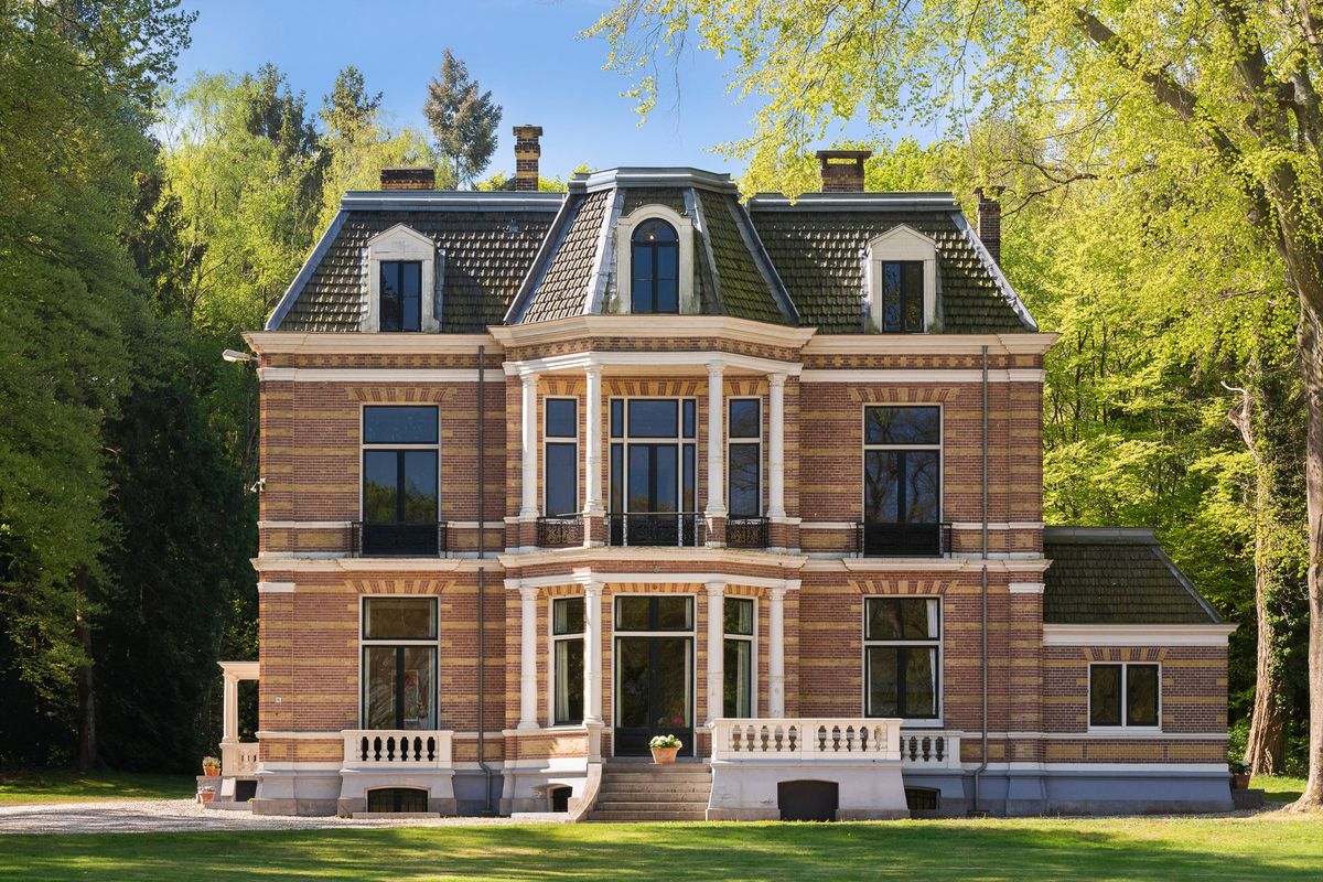 het hoofdgebouw van buitenplaats ’t Benthuys in Baarn, een baksteen landhuis met mansardedak